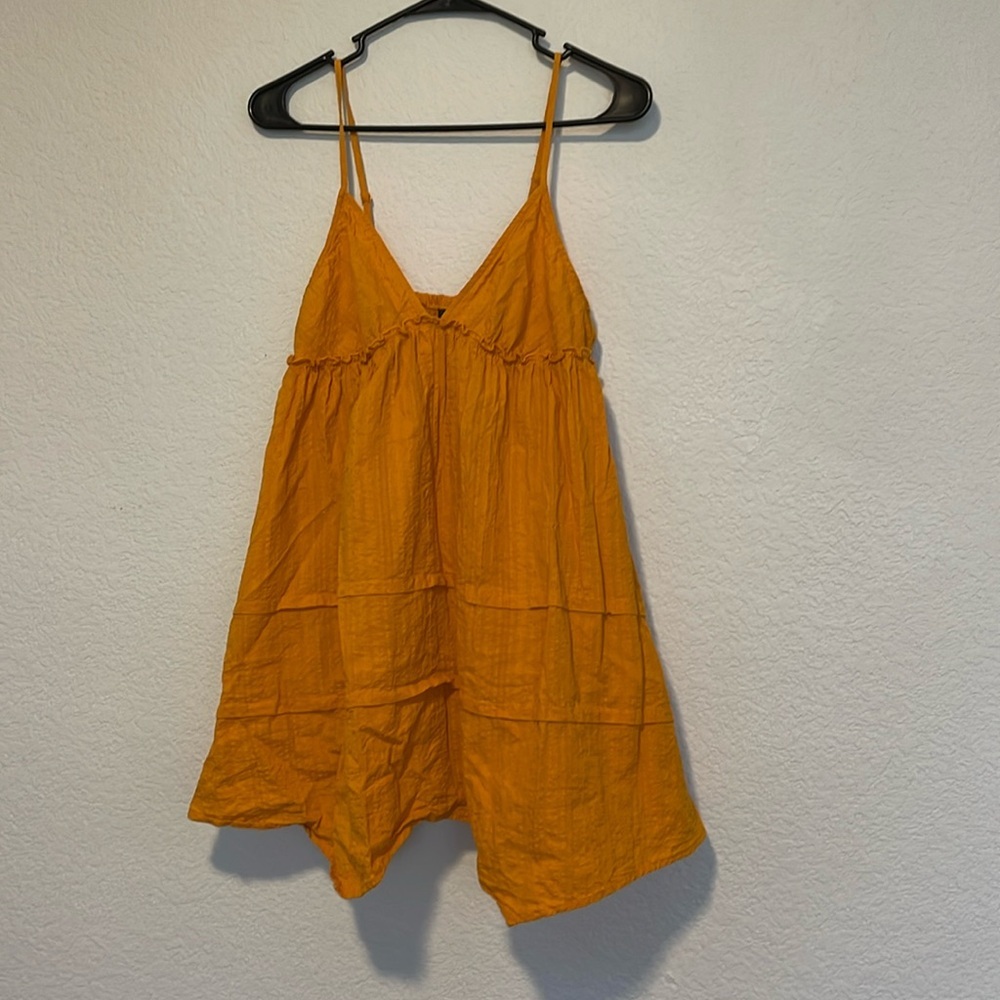 Small orange colored flowy top